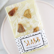 Load image into Gallery viewer, The Pina Colada One - The Home Of Fully Loaded boozy Chocolate. Large Slabbs of boozy chocolate with a variety of alcoholic ganaches; gin, rum, whisky, amaretto, baileys and toppings. Available as monthly subscriptions.