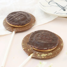 Load image into Gallery viewer, Milk Chocolate Jaffa Cake Lollipop - The Home Of Fully Loaded boozy Chocolate. Large Slabbs of boozy chocolate with a variety of alcoholic ganaches; gin, rum, whisky, amaretto, baileys and toppings. Available as monthly subscriptions.

