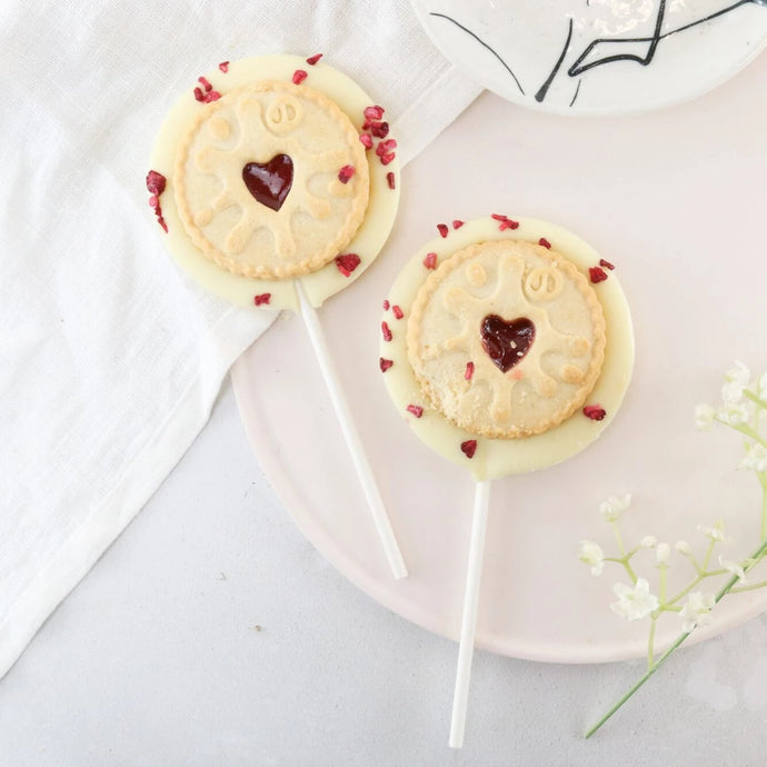 White Chocolate Jammy Dodger Lollipop - The Home Of Fully Loaded boozy Chocolate. Large Slabbs of boozy chocolate with a variety of alcoholic ganaches; gin, rum, whisky, amaretto, baileys and toppings. Available as monthly subscriptions.